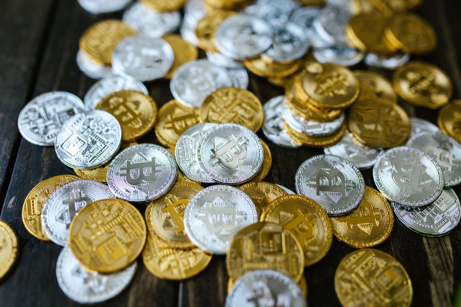 Assorted cryptocurrency coins on a dark surface