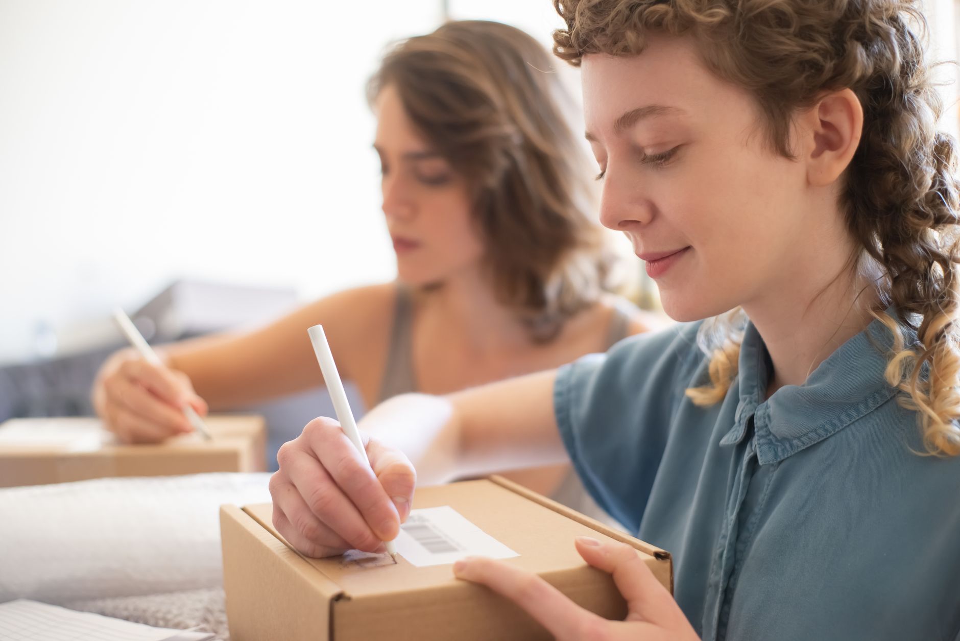 Small business owner preparing products for online orders at a workspace