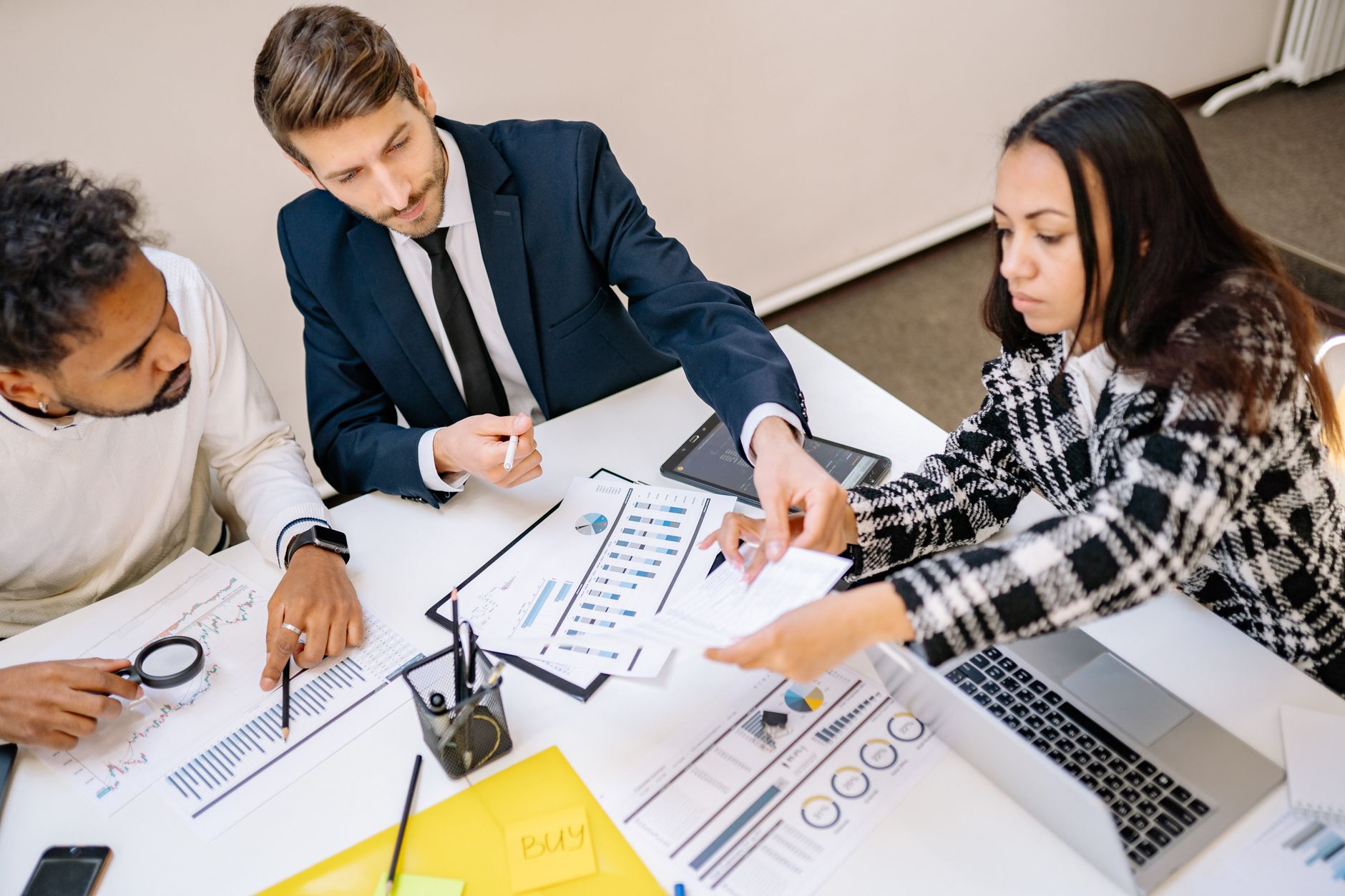 Business professionals reviewing financial documents during a lending or credit discussion