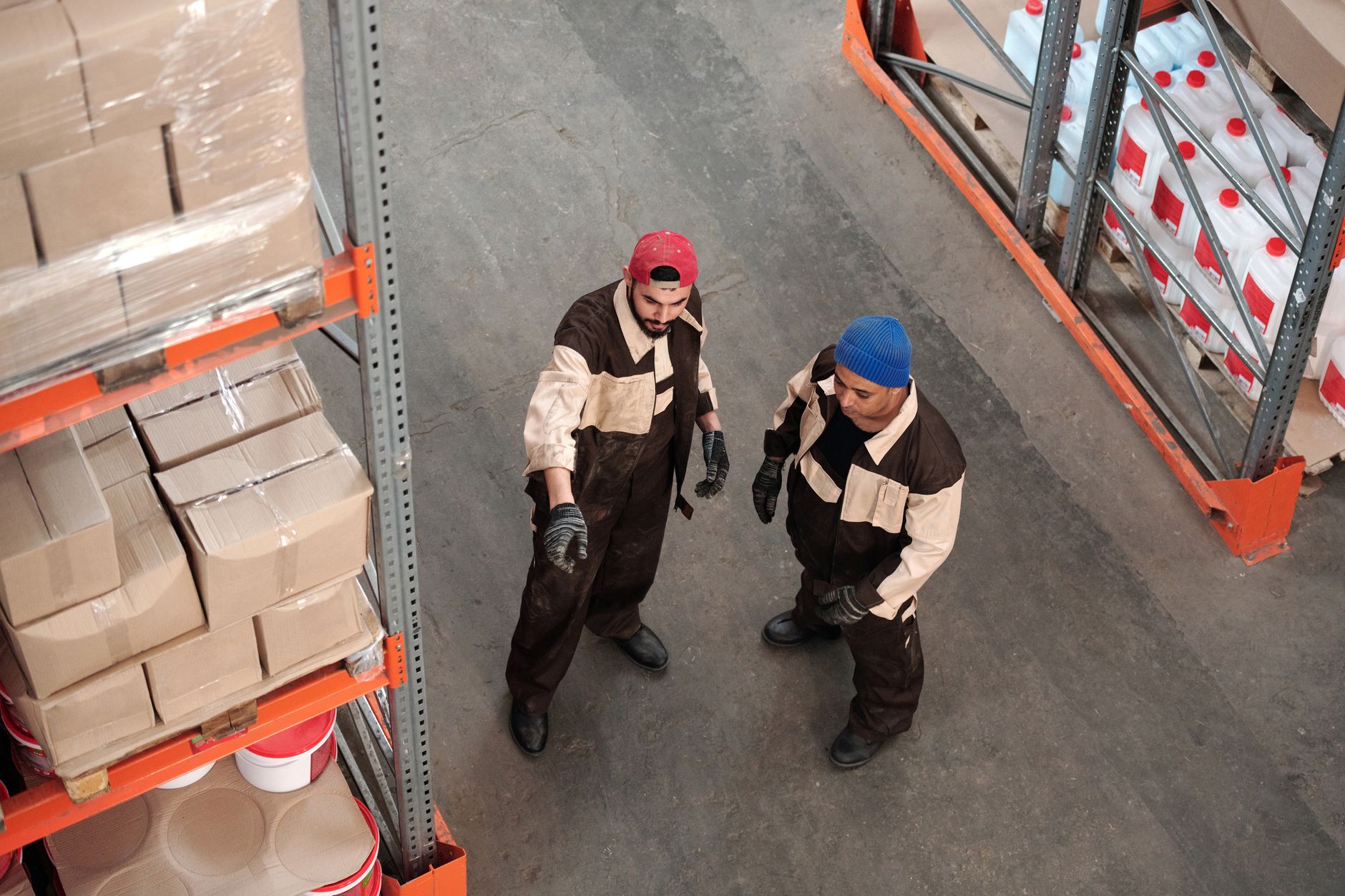 Large warehouse filled with organized clothing inventory on shelving racks