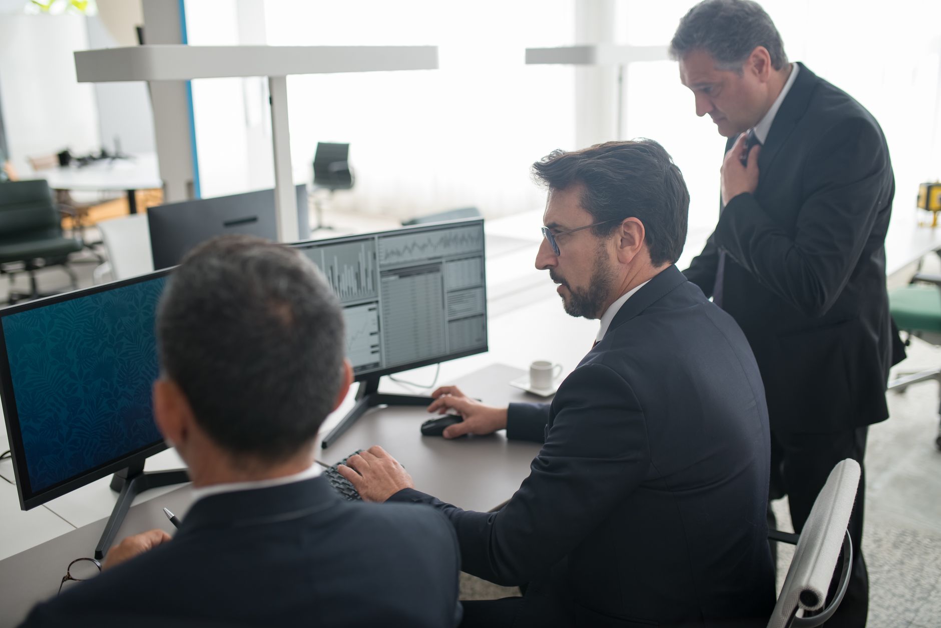 Traders monitoring screens on a busy financial trading floor