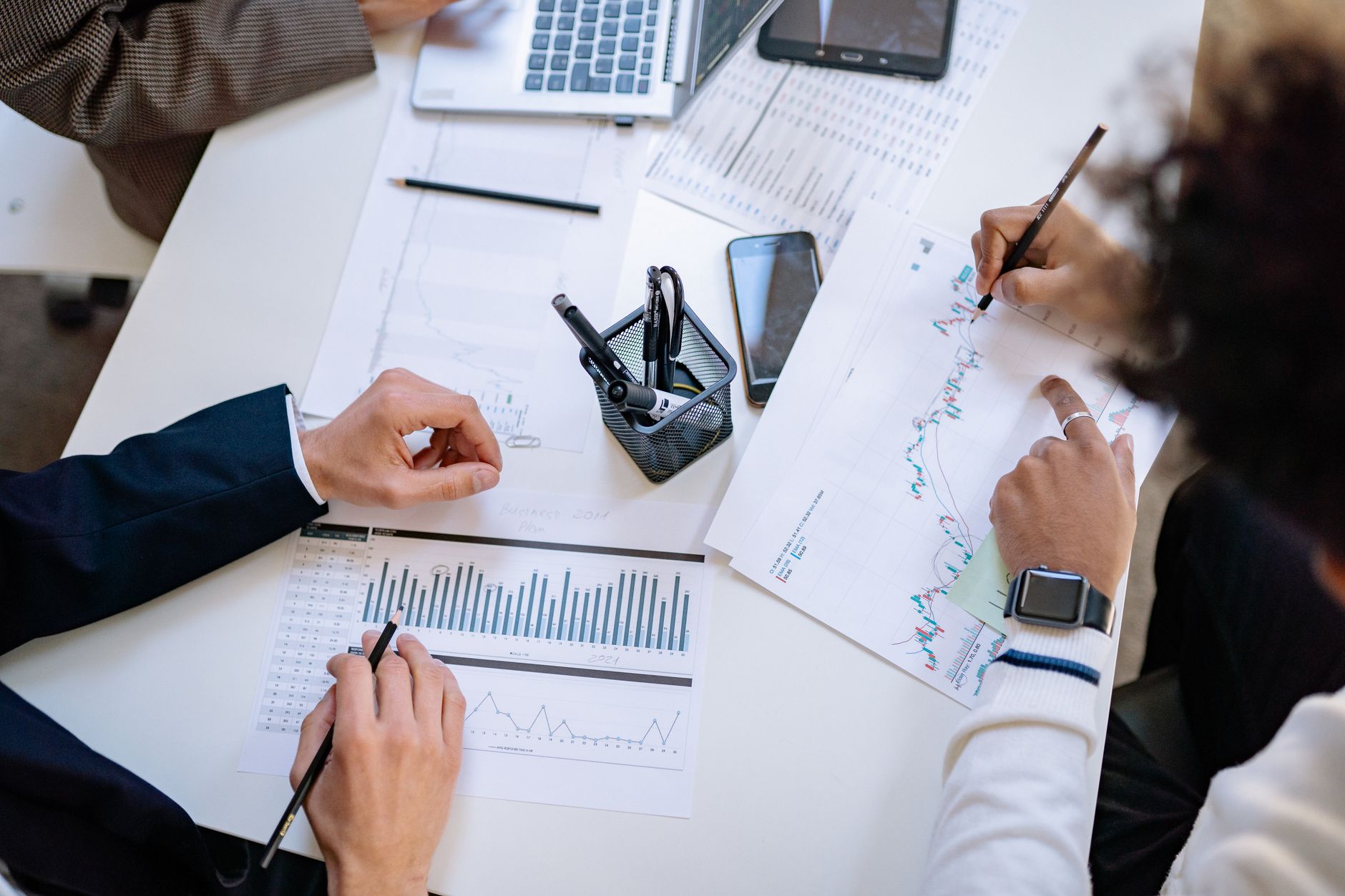 Business professionals reviewing performance charts in a modern office setting