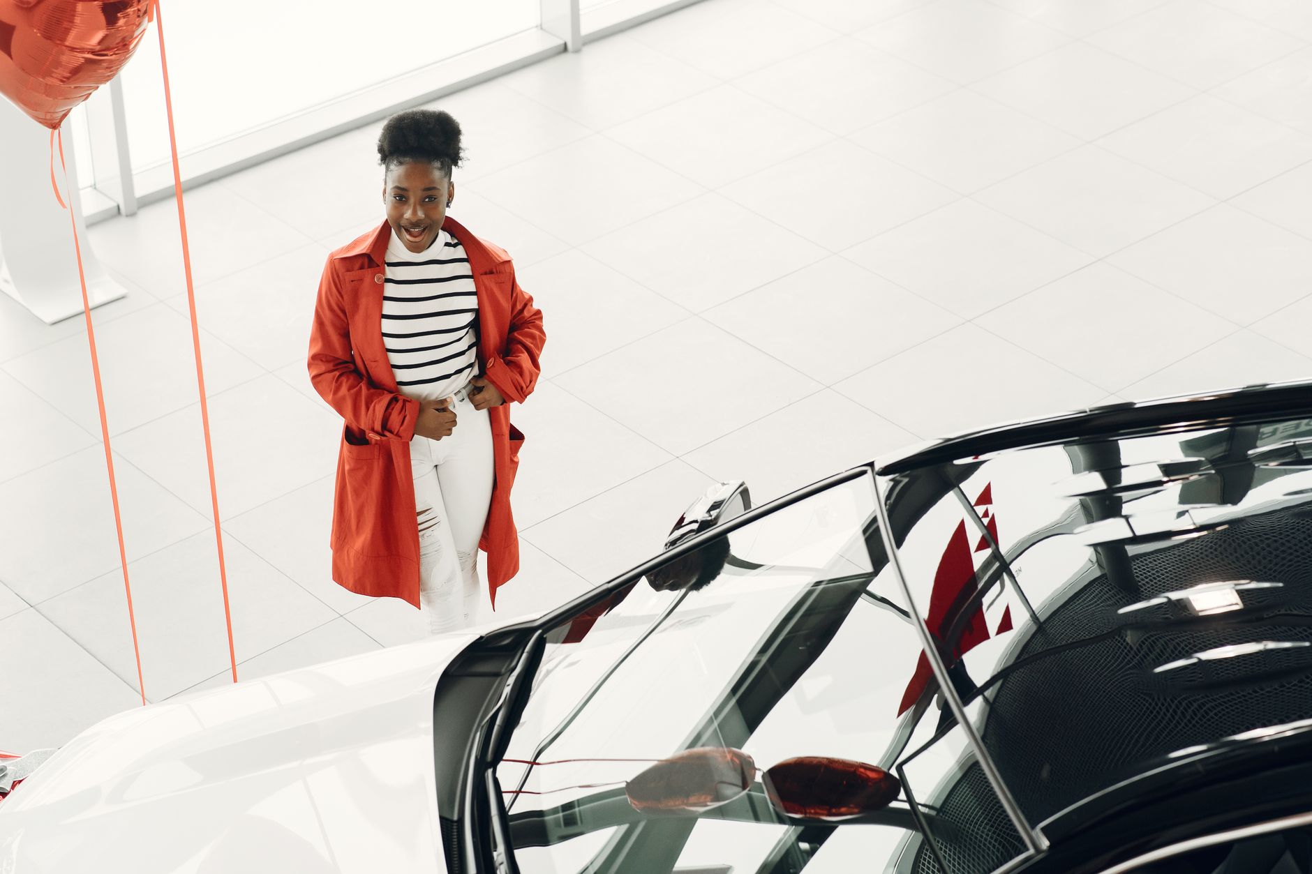 Vehicle showroom interior displaying multiple car models available for sale
