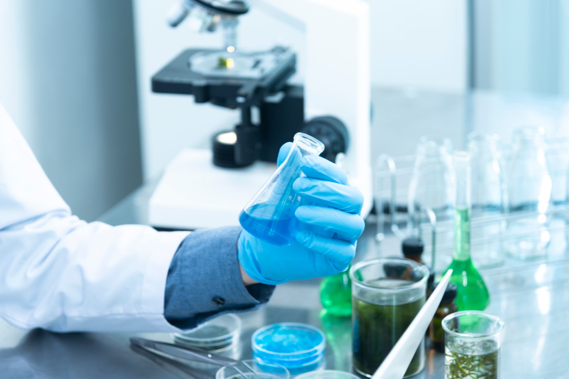 Scientist working in a pharmaceutical research laboratory representing drug manufacturing investment