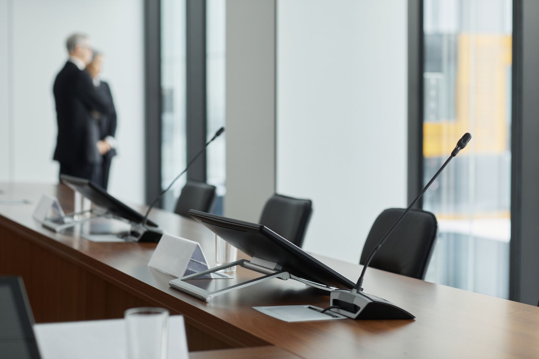 Empty corporate boardroom with long table and chairs representing executive decision-making