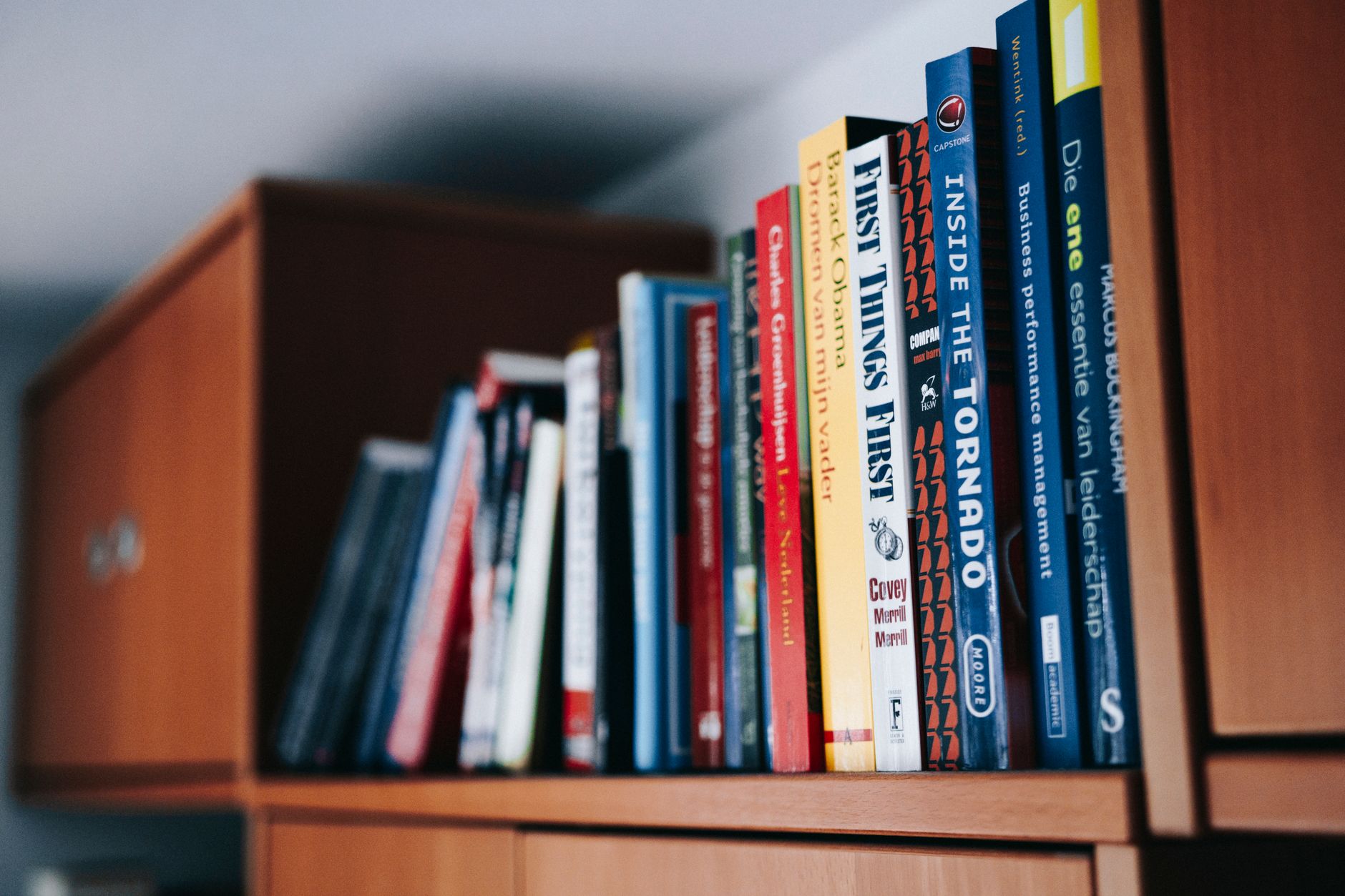 Row of books on a library shelf representing audiobook catalog and publishing industry