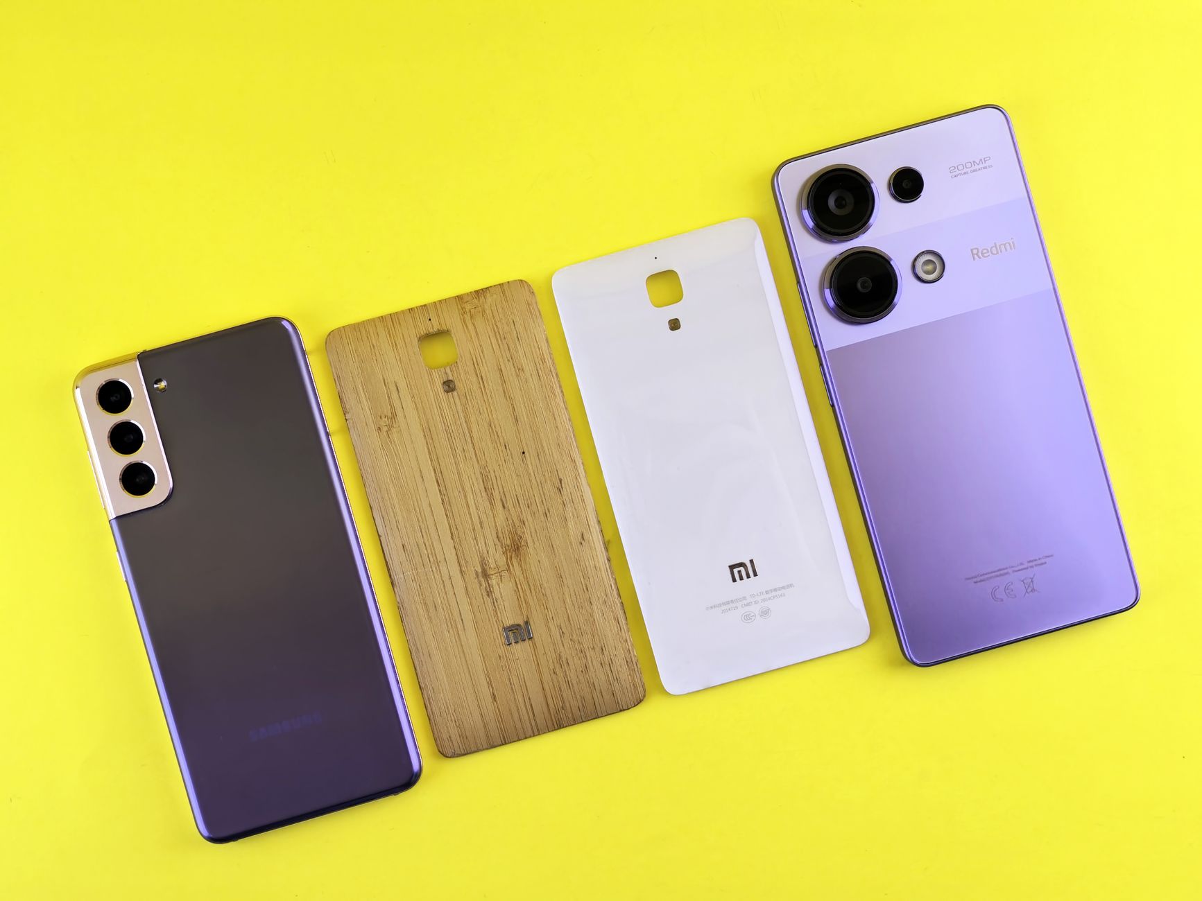Person holding a new smartphone next to an older model for comparison