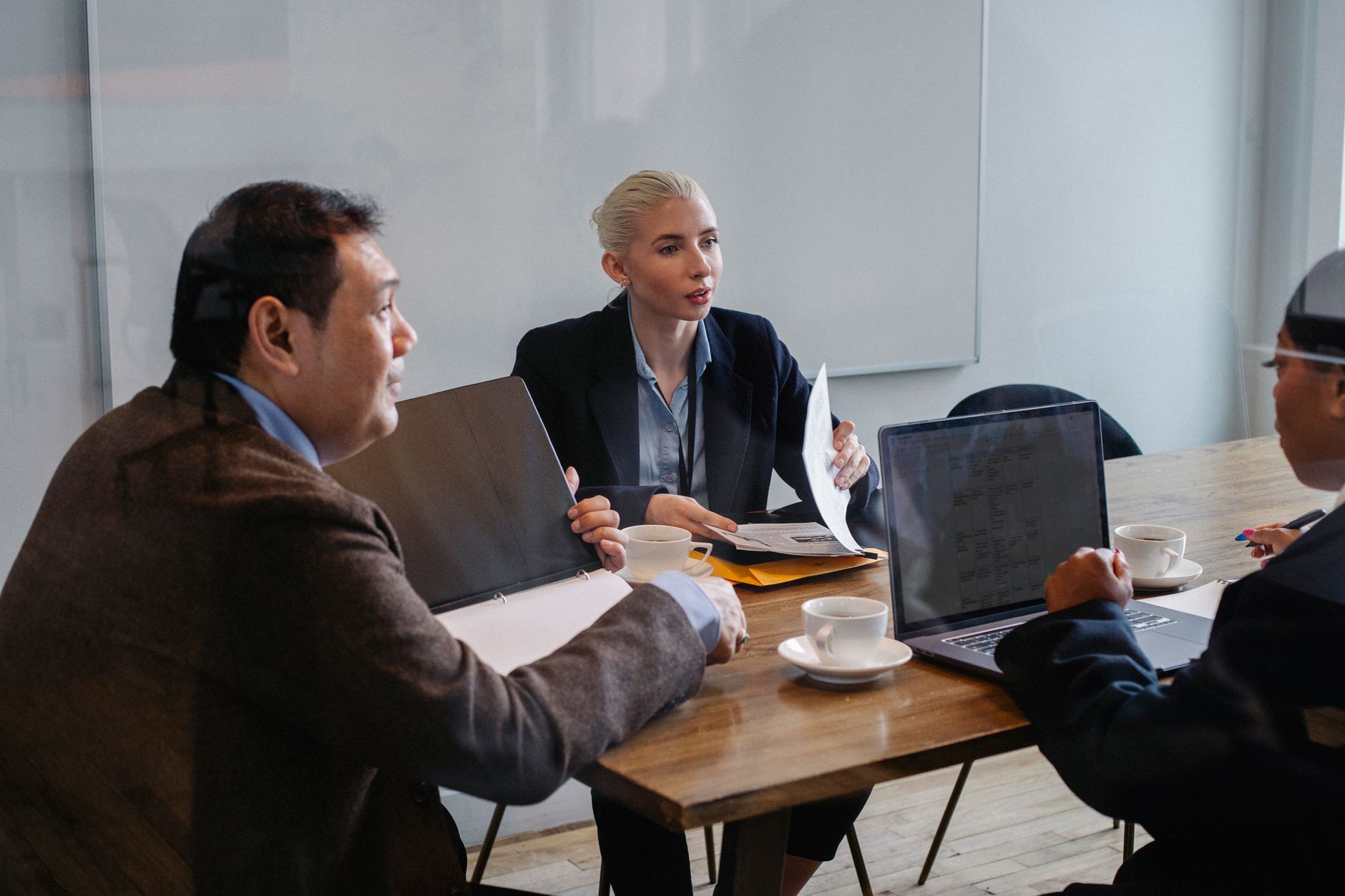 Business professionals reviewing technology strategy documents in a corporate meeting room