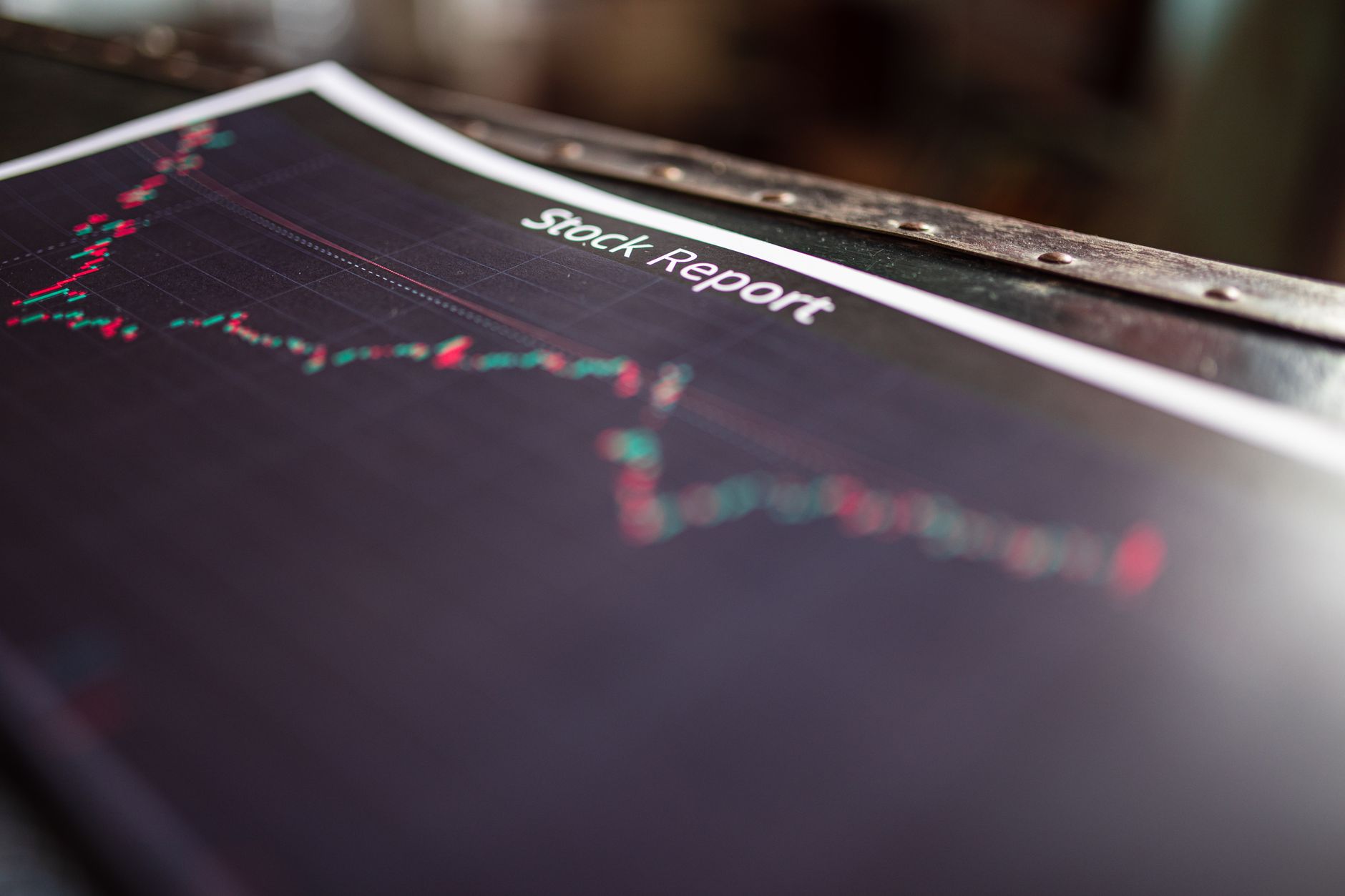 Financial analyst reviewing portfolio performance charts on multiple monitors