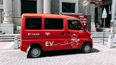 An electric delivery van parked on a city street representing fleet EV operations