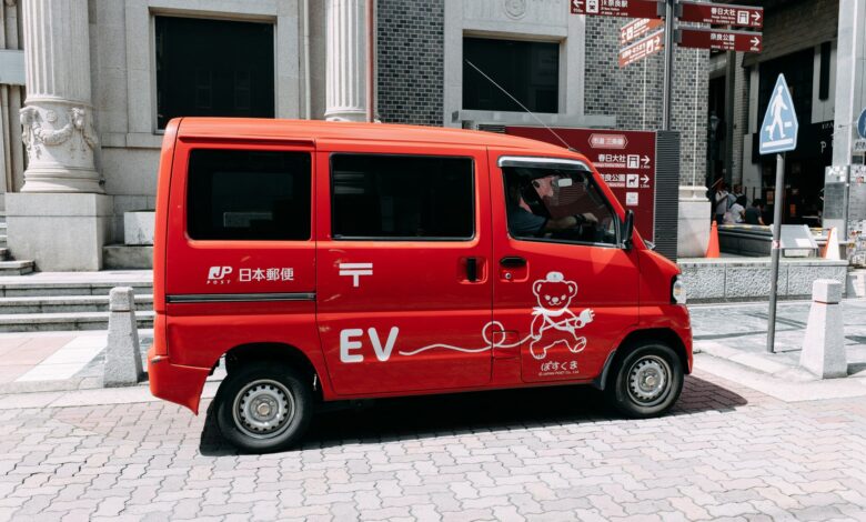 An electric delivery van parked on a city street representing fleet EV operations