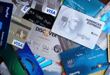 Multiple credit cards fanned out on a desk representing payment network competition