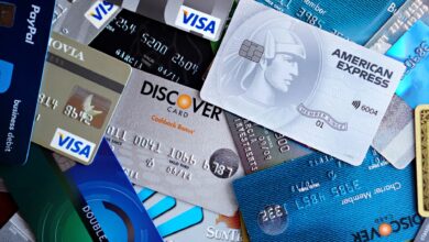 Multiple credit cards fanned out on a desk representing payment network competition
