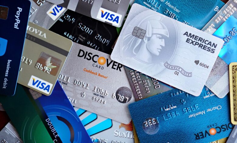 Multiple credit cards fanned out on a desk representing payment network competition