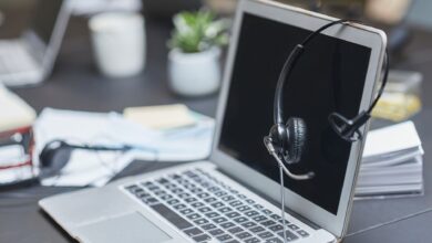 Business professionals working with AI tools on laptops in a modern office environment