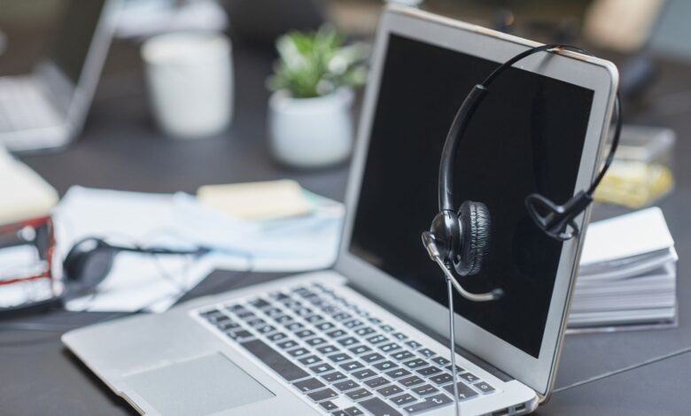 Business professionals working with AI tools on laptops in a modern office environment