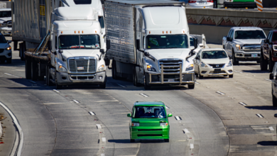 A self-driving vehicle traveling on an urban road representing the rise of robotaxi services