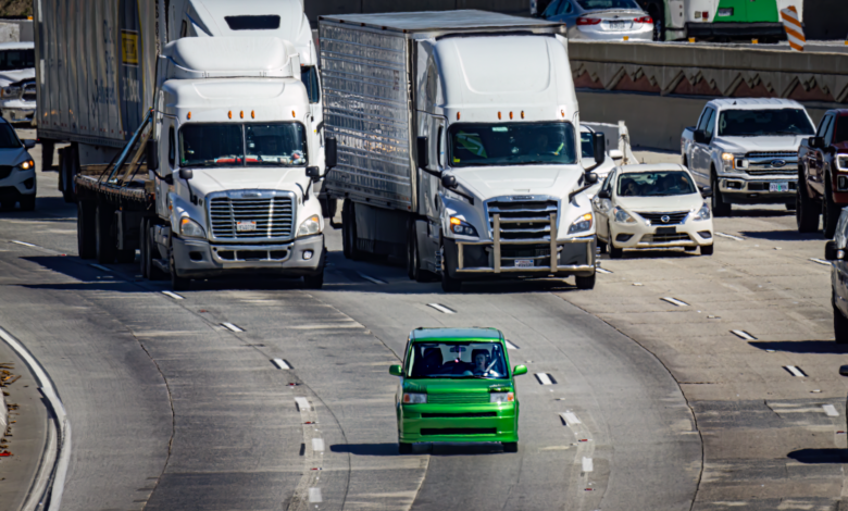 A self-driving vehicle traveling on an urban road representing the rise of robotaxi services