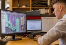 Designer working on a UI design tool on a desktop computer screen