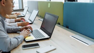Business professionals reviewing enterprise software workflows on large monitors in a modern office
