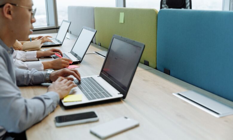 Business professionals reviewing enterprise software workflows on large monitors in a modern office