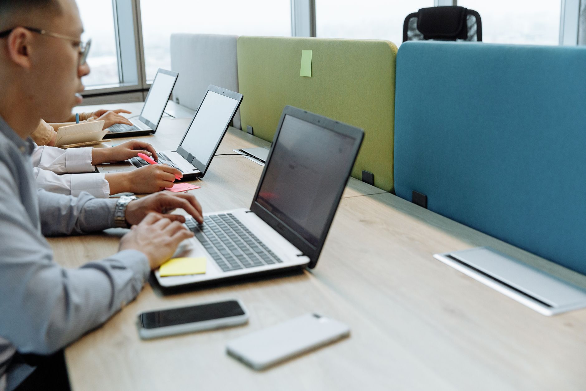Business professionals reviewing enterprise software workflows on large monitors in a modern office
