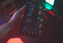 Person using a smartphone to trade cryptocurrency on a brokerage app