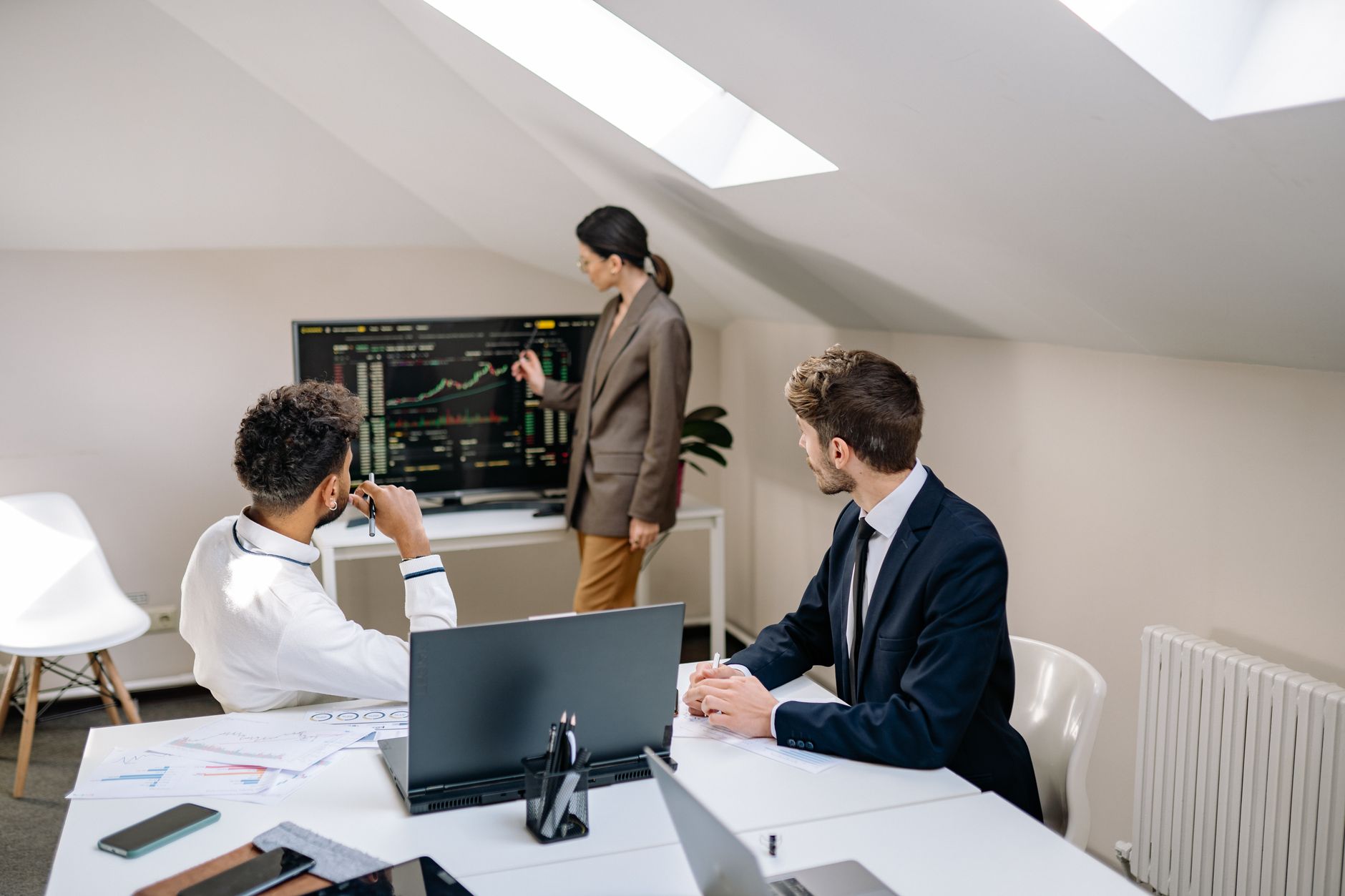 Business professionals in a formal finance meeting discussing investment strategy