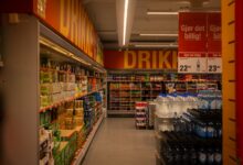 Wide retail store aisle with product shelves representing consumer goods advertising competition