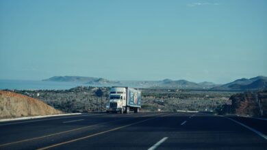 A semi-truck driving along an open highway representing freight logistics and trucking industry