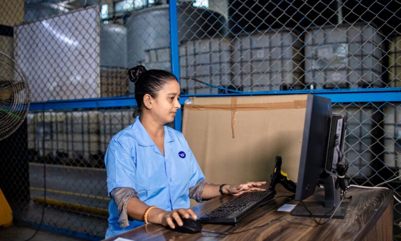 A person working at a desk with multiple screens showing app workflows and automation dashboards