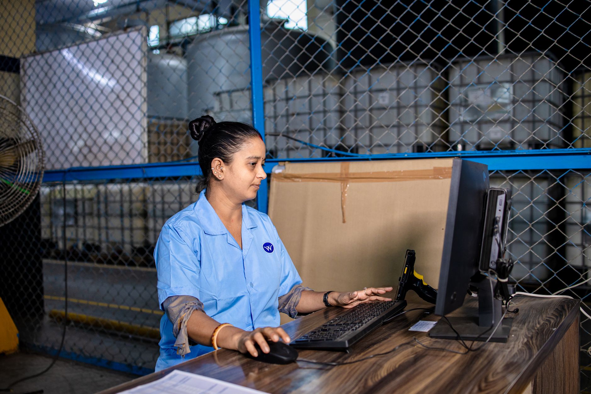 A person working at a desk with multiple screens showing app workflows and automation dashboards