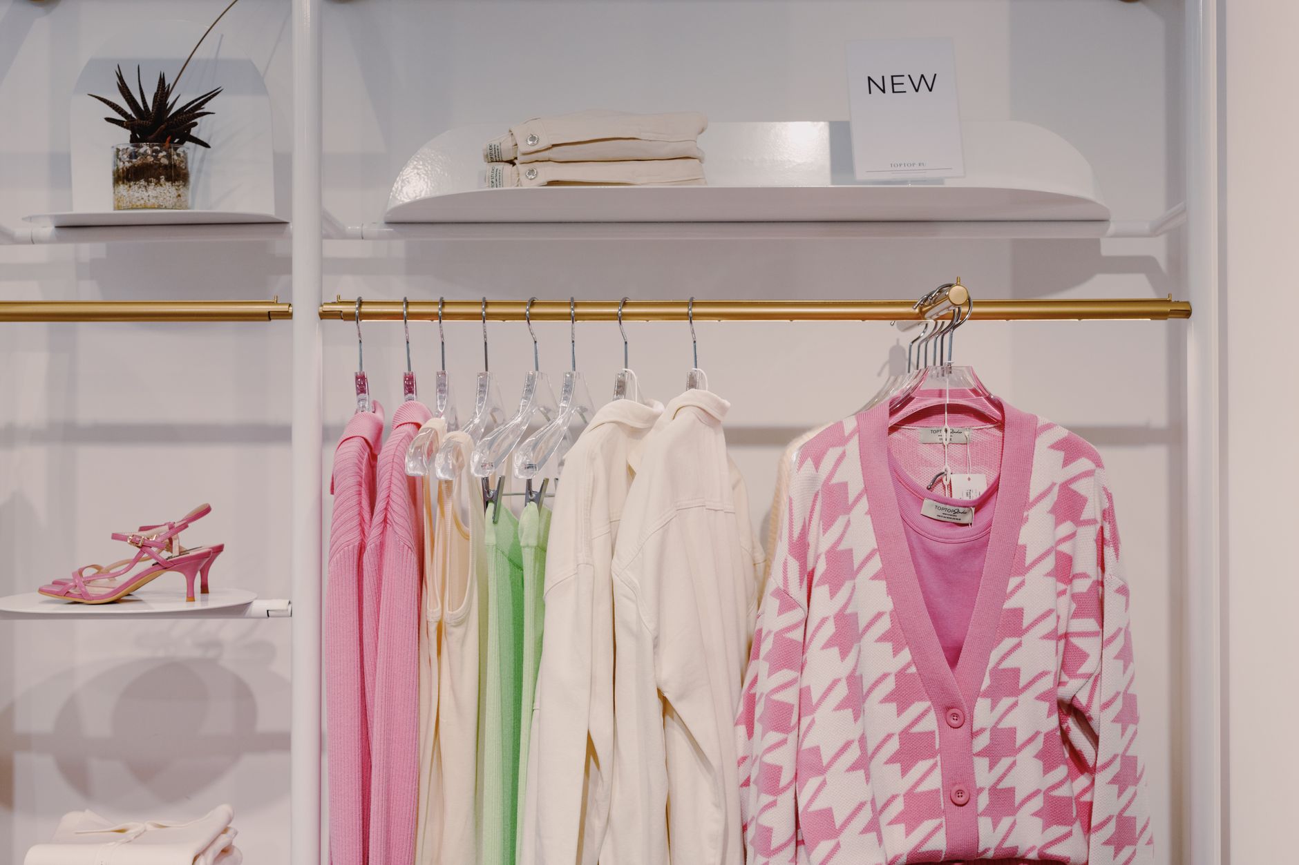 Interior of a modern fast-fashion clothing store with racks of garments