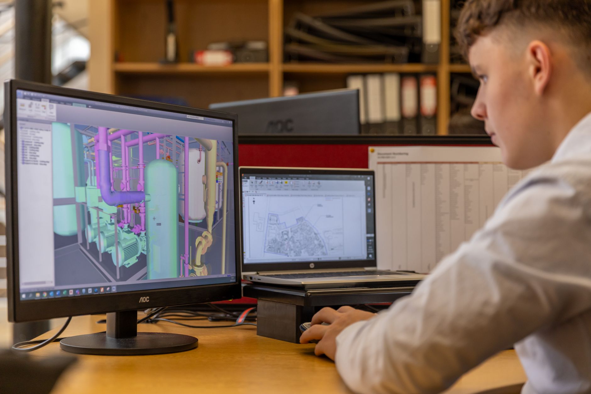 Designer working on a UI design tool on a desktop computer screen