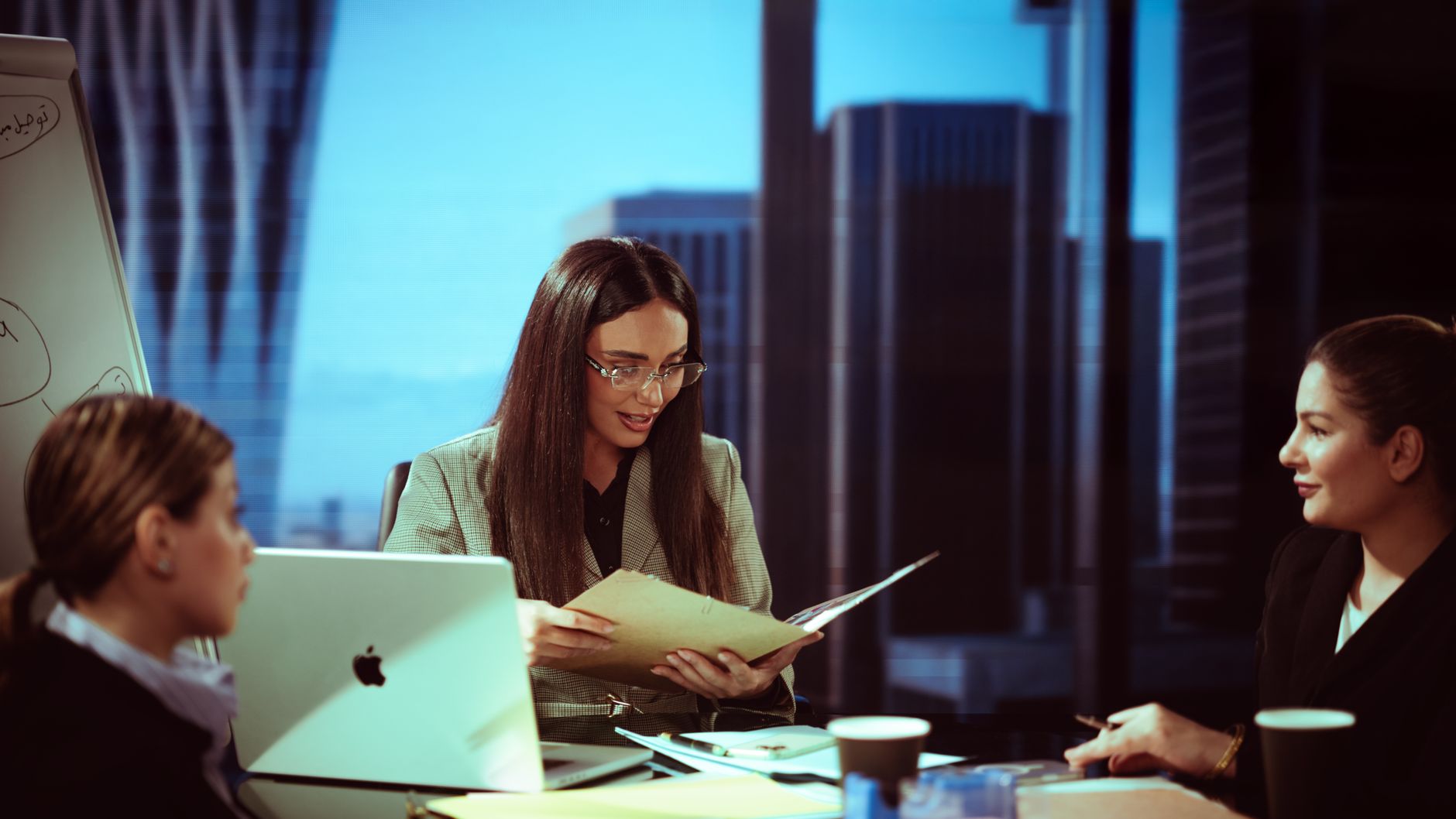 Business professionals in a corporate meeting discussing financial strategy in an Asian city office