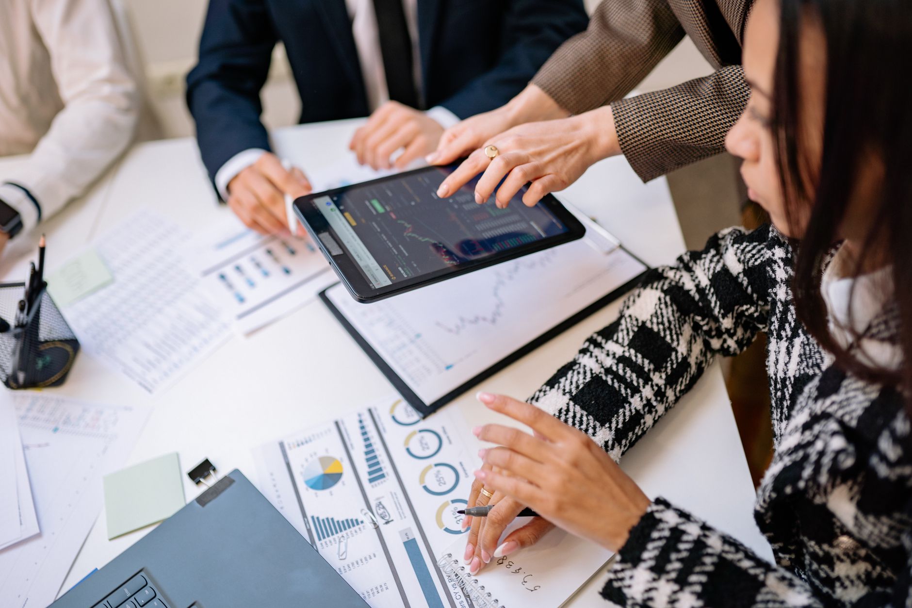 Business professionals reviewing technology platform data on screens during a meeting