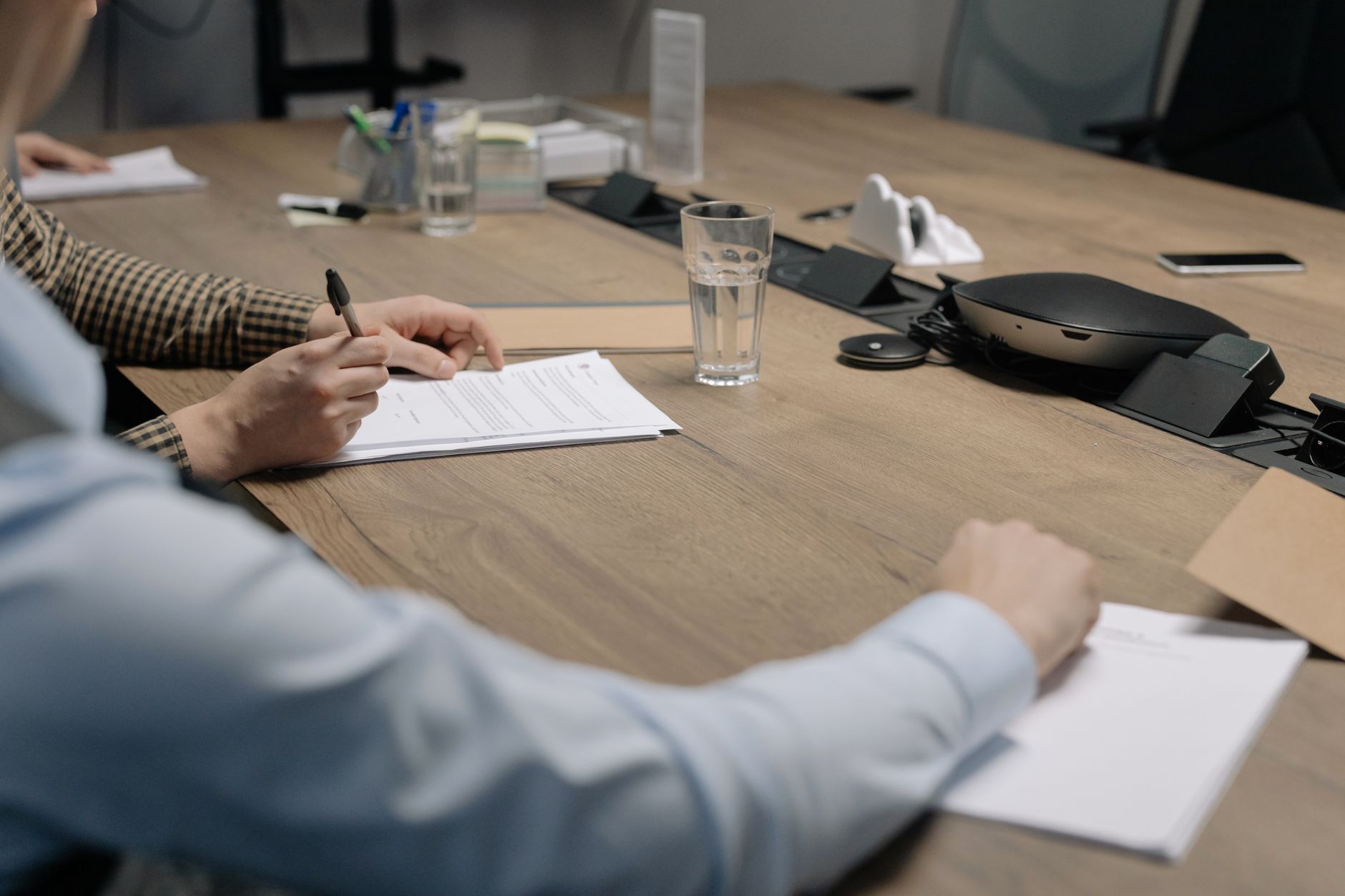 Two professionals in a meeting representing a complex technology partnership negotiation