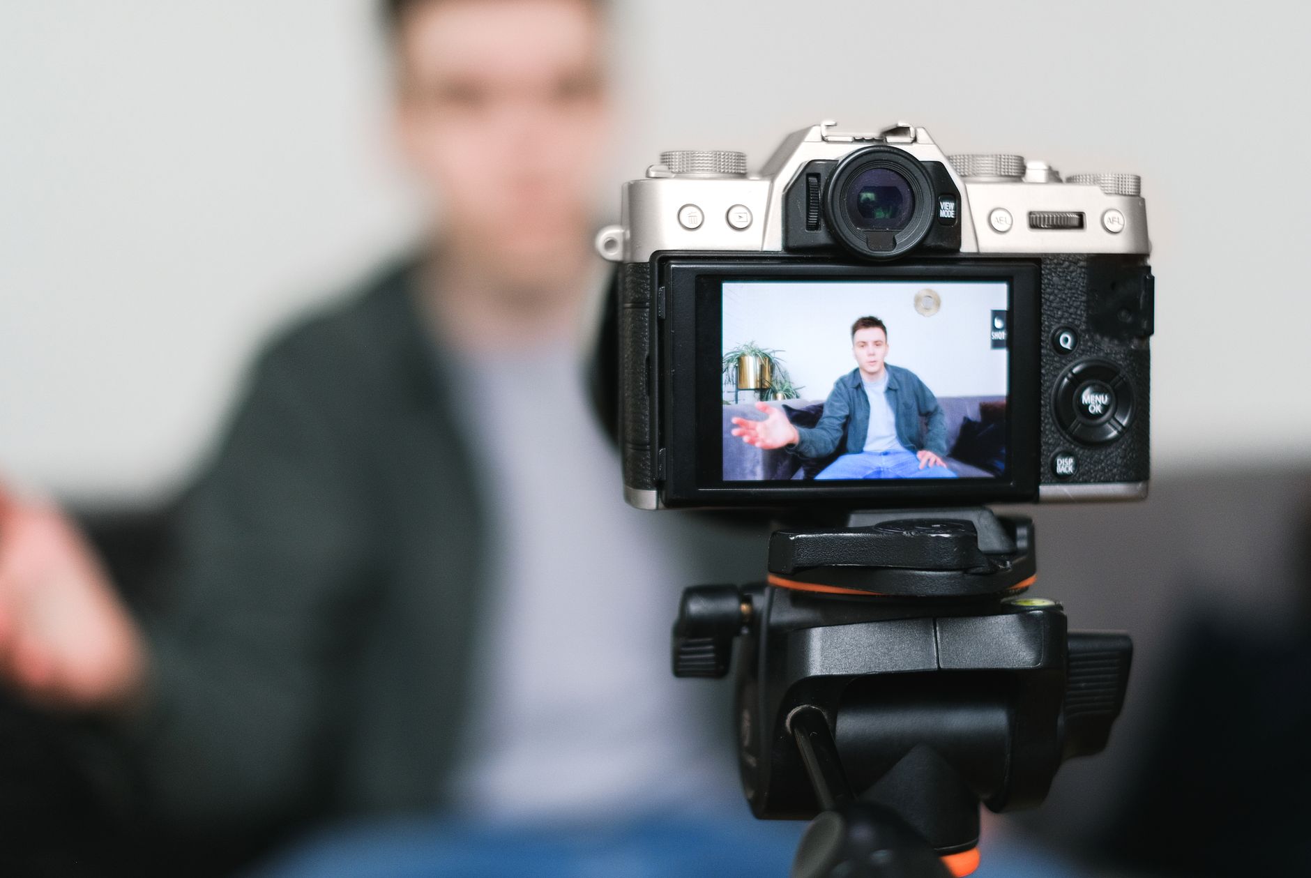 Young creator filming a product video with a smartphone mounted on a tripod