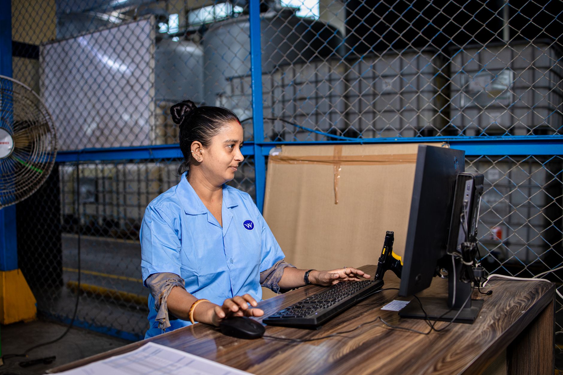 Worker using digital technology in an industrial warehouse setting