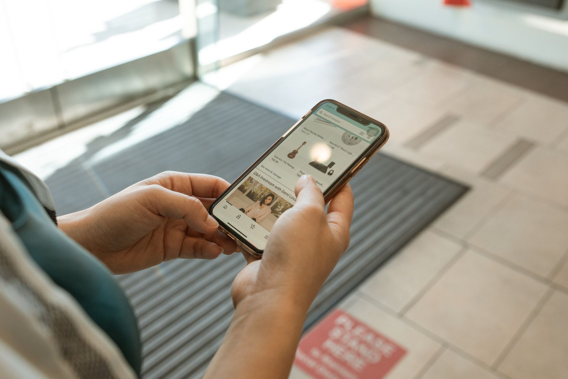 Person browsing clothing on a smartphone for online fashion shopping