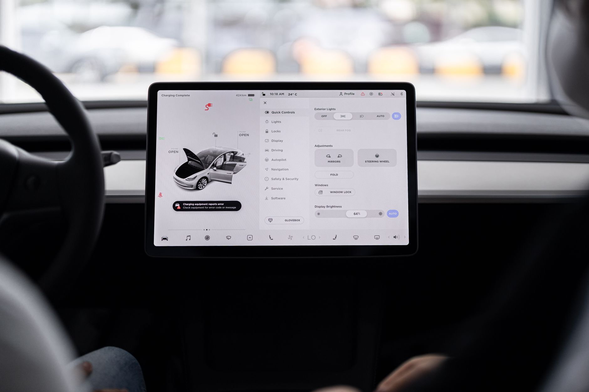 Interior of a modern electric vehicle showing digital dashboard and software interface