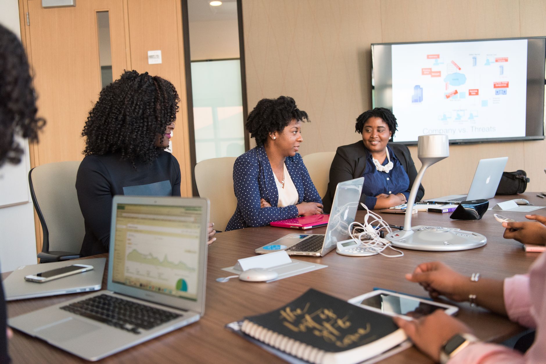 Corporate team reviewing software options on a laptop in a conference room