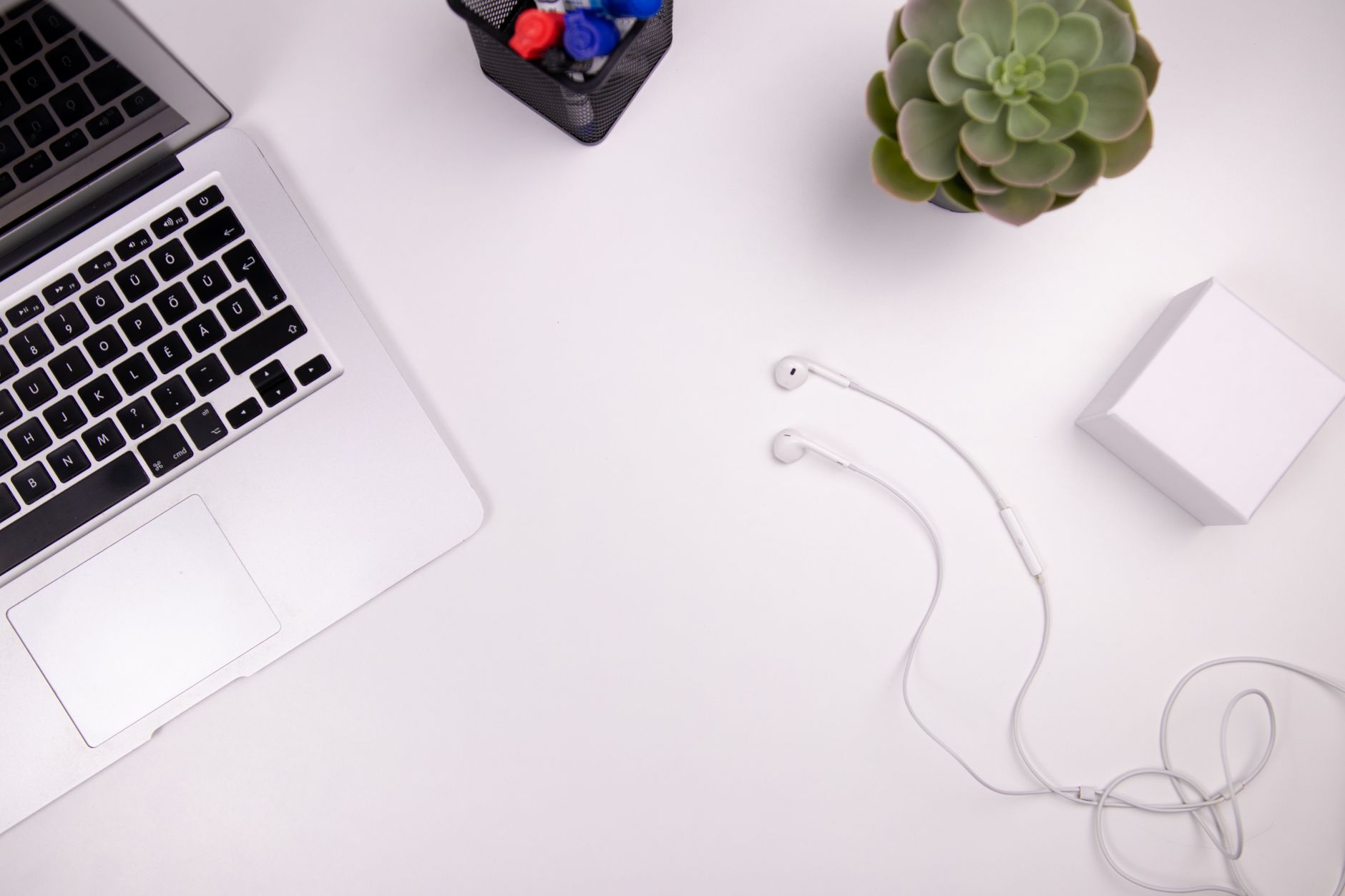 Creative professional working at a minimalist desk with design tools open on screen
