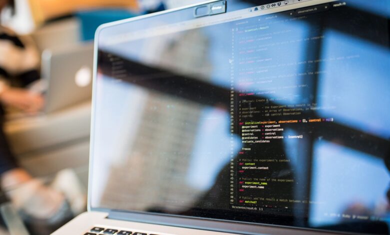 Developer working on code on a laptop screen in a modern workspace