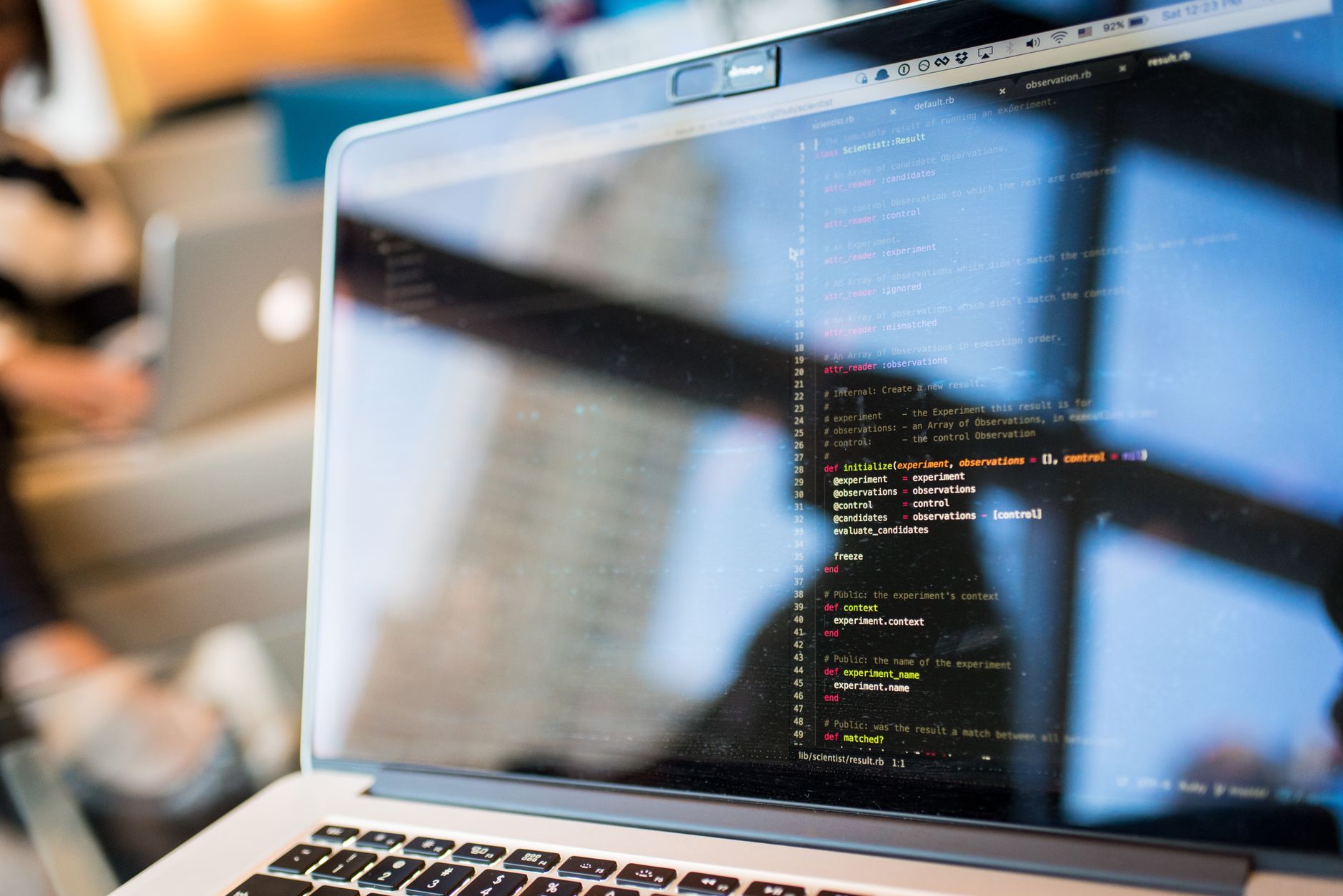 Developer working on code on a laptop screen in a modern workspace