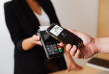Person using smartphone to complete a mobile payment at checkout