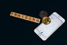 Person viewing a cryptocurrency trading app on a smartphone screen
