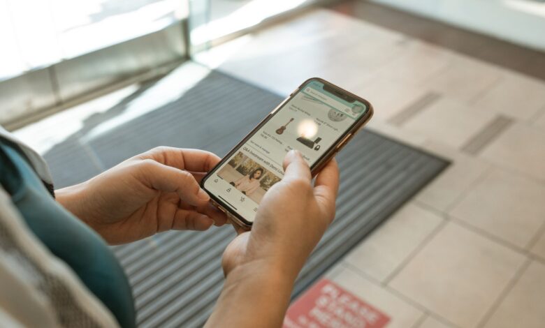 Person browsing a shopping app on a smartphone with product listings visible on screen