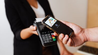 Person using smartphone to complete a mobile payment at checkout