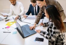 Team members collaborating in a modern open office workspace